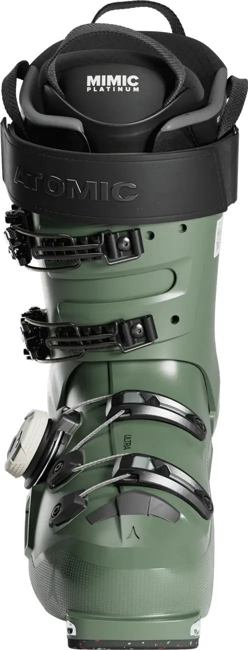 Green ski boot with black top and 'Atomic' branding on a white background