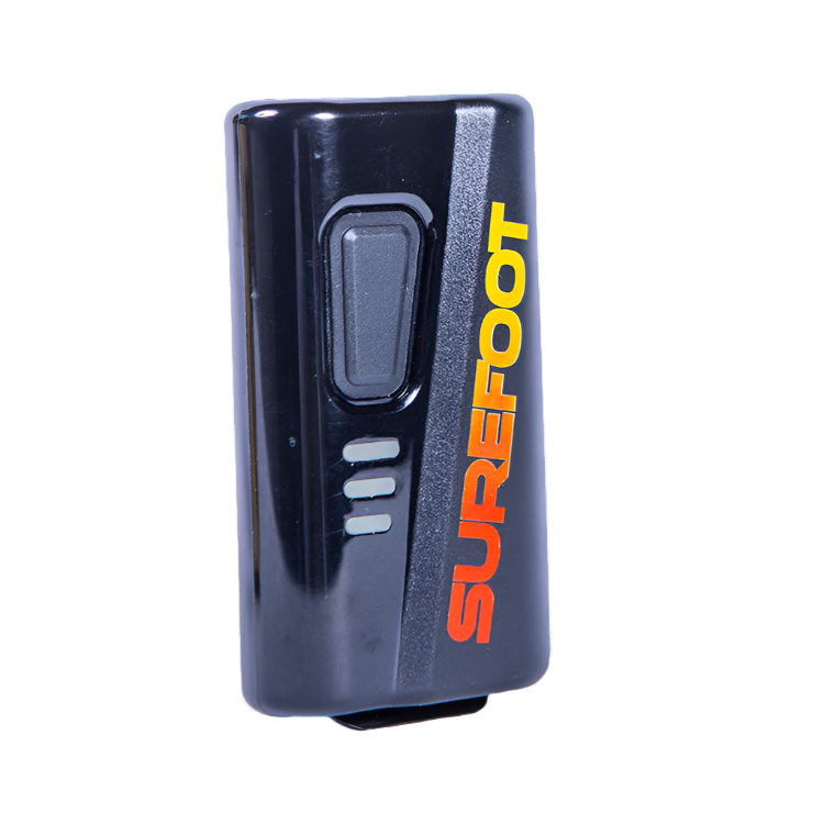 Single Black ski boot heater battery, with Surefoot written vertically in a red to yellow fade. The battery has one button and three light up bars.