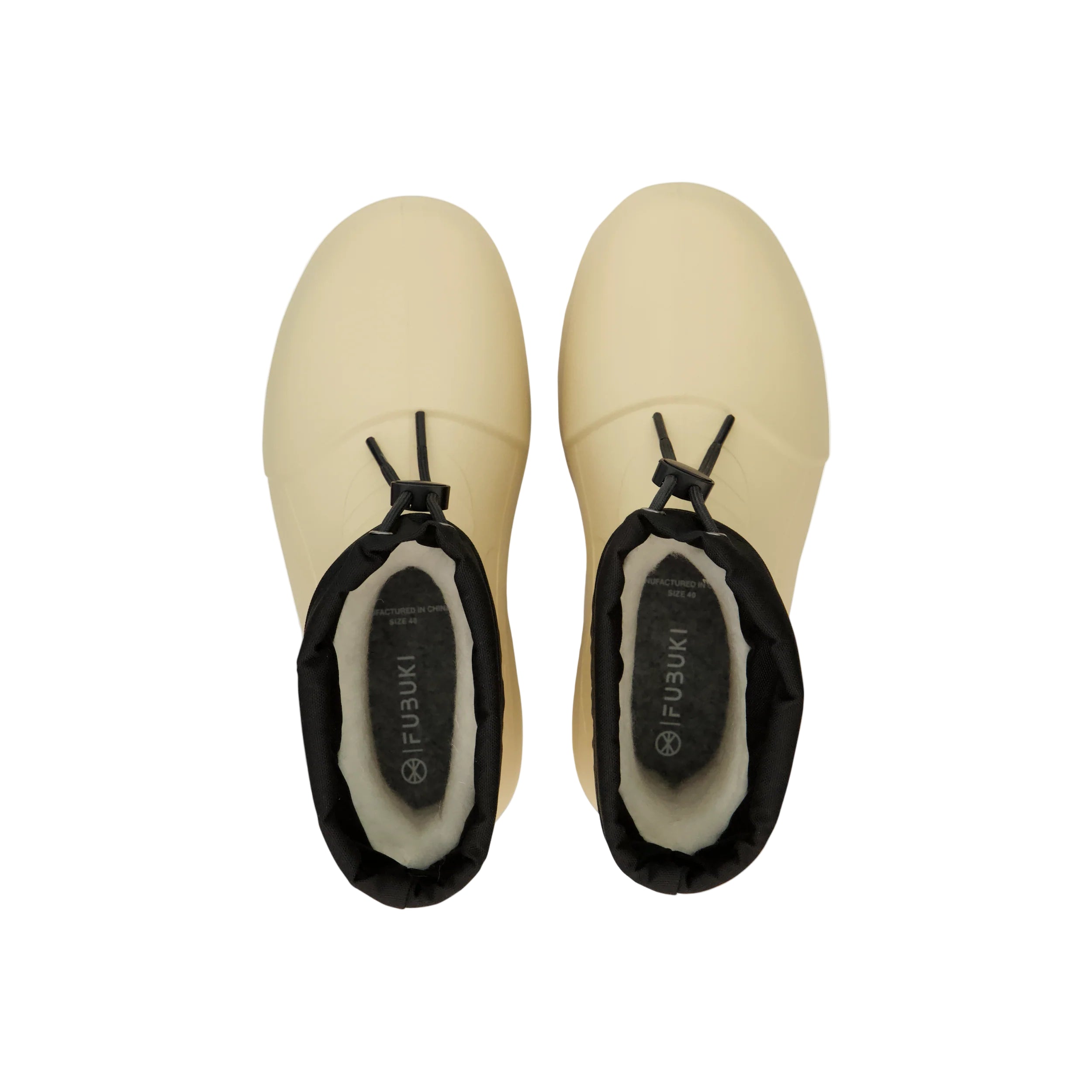 Pair of beige clogs with black soles on a white background