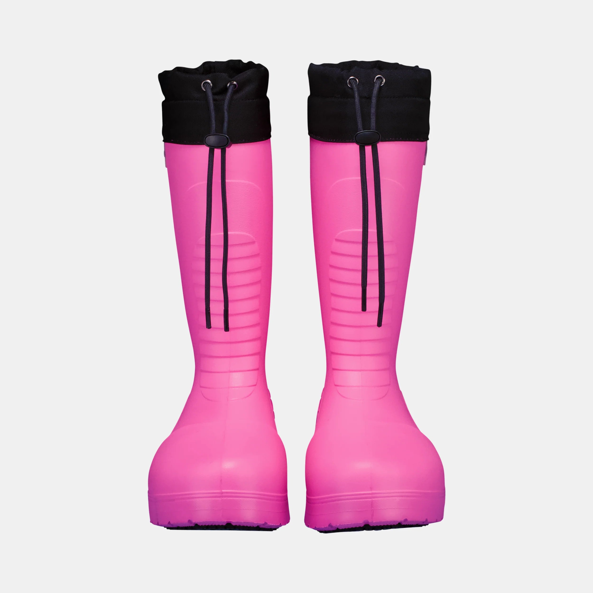 Pair of pink rain boots with black tops on a light gray background