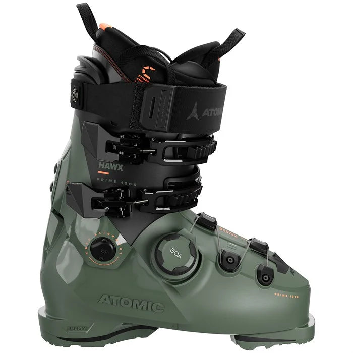 Green ski boot with black straps on a white background