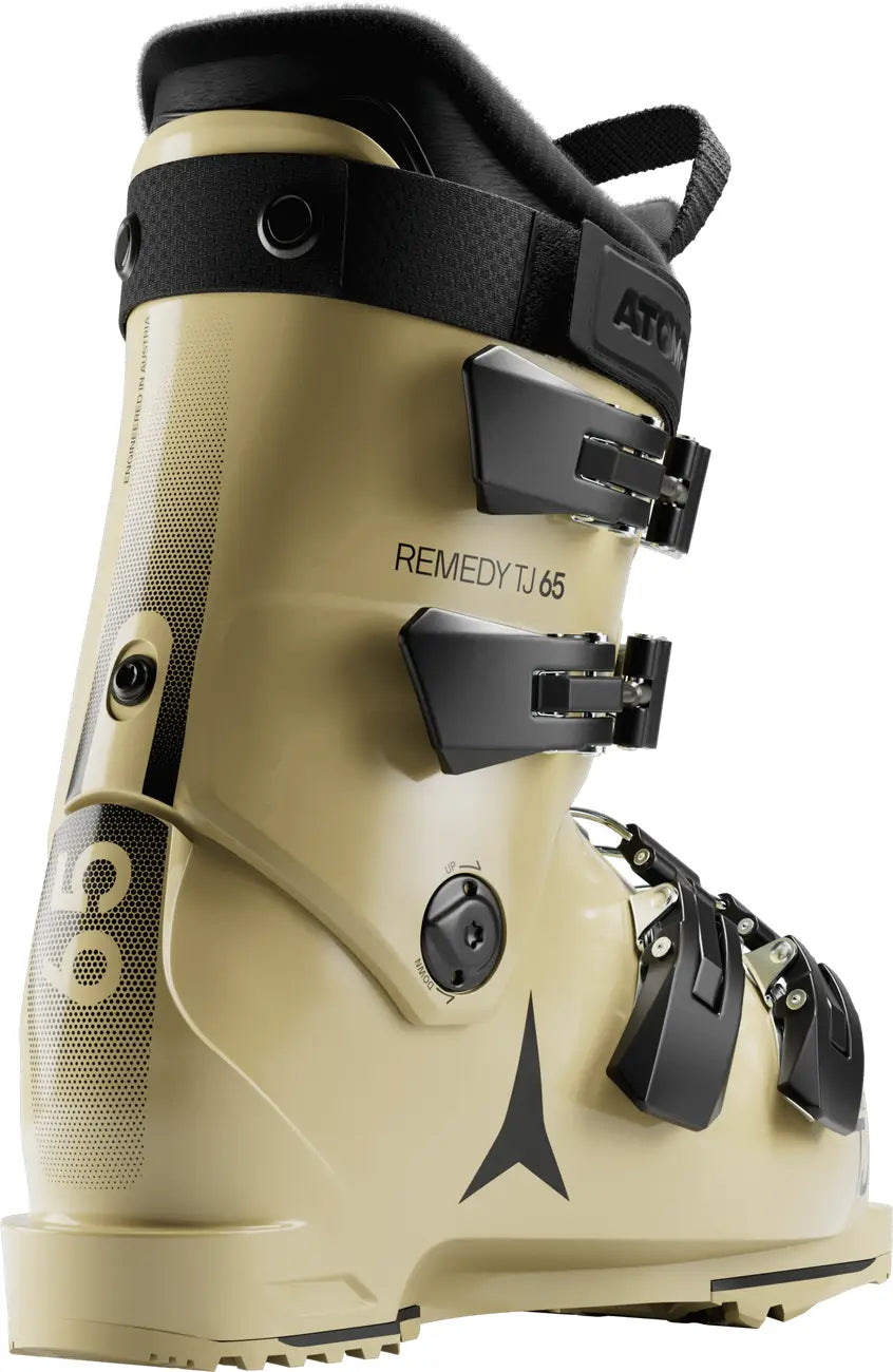 Beige ski boot with black straps and  Remedy 65 branding on a white background.