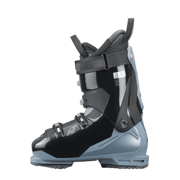 The inner side of the ski boot is a shiny black, with the blue still poking out of the bottom over the heel.