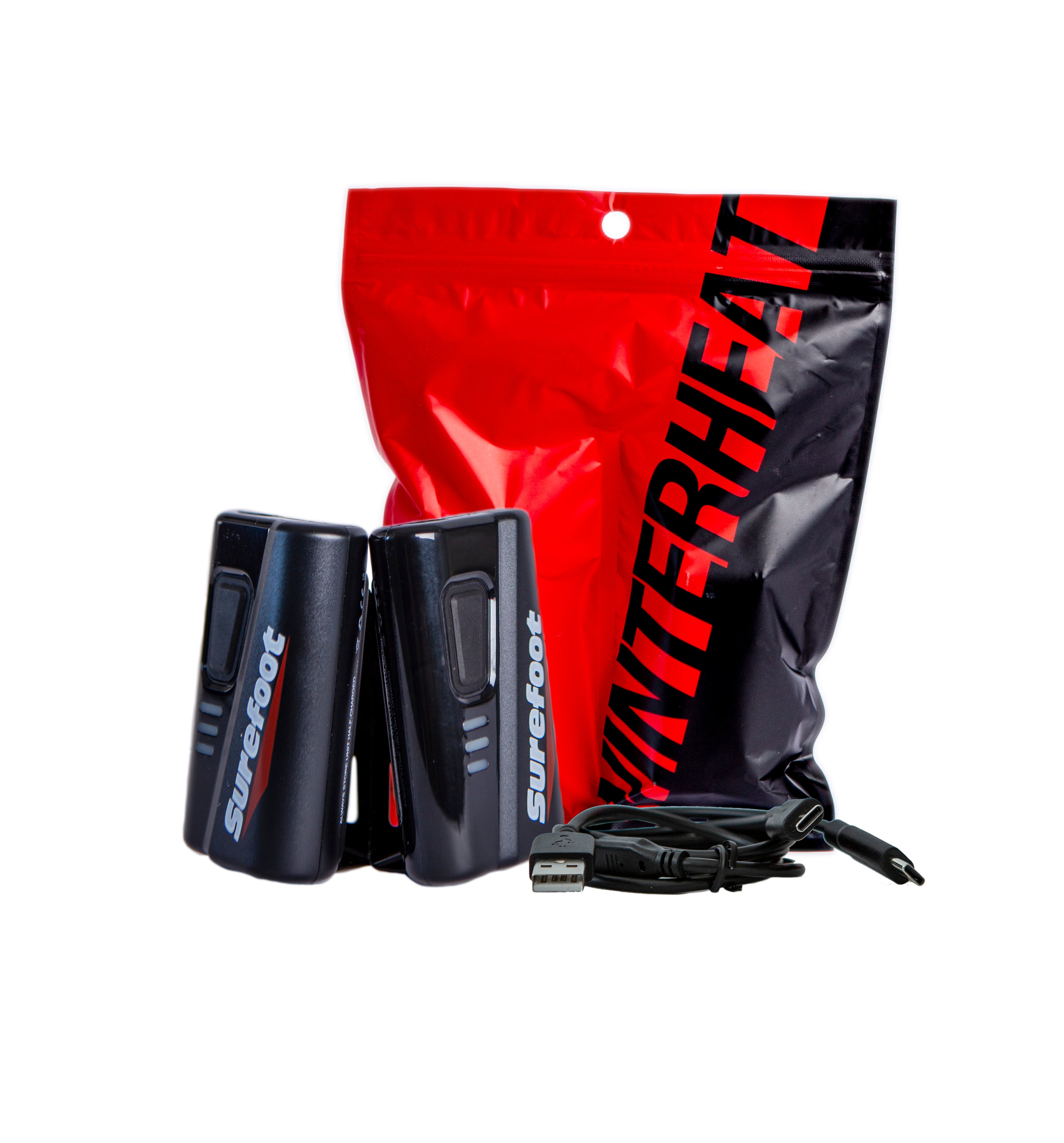 Surefoot Winterheat red and black packaging behind two small Surefoot Winterheat battery packs and USB-C charging cable laying next to them,