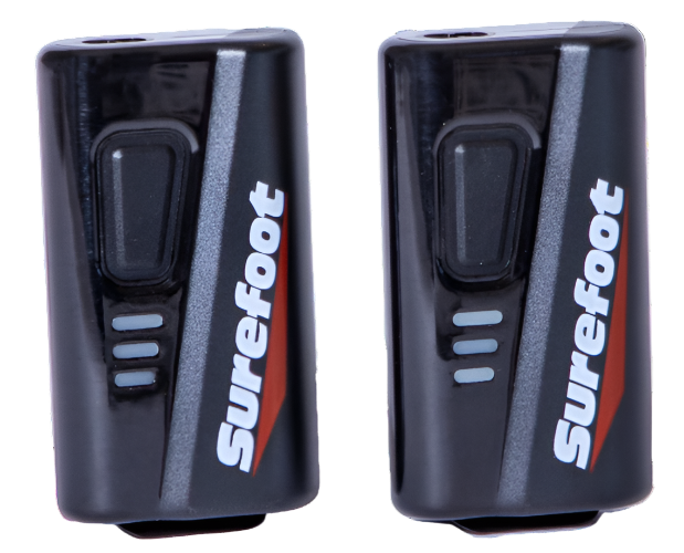 Two small black battery packs with button and Surefoot logo.