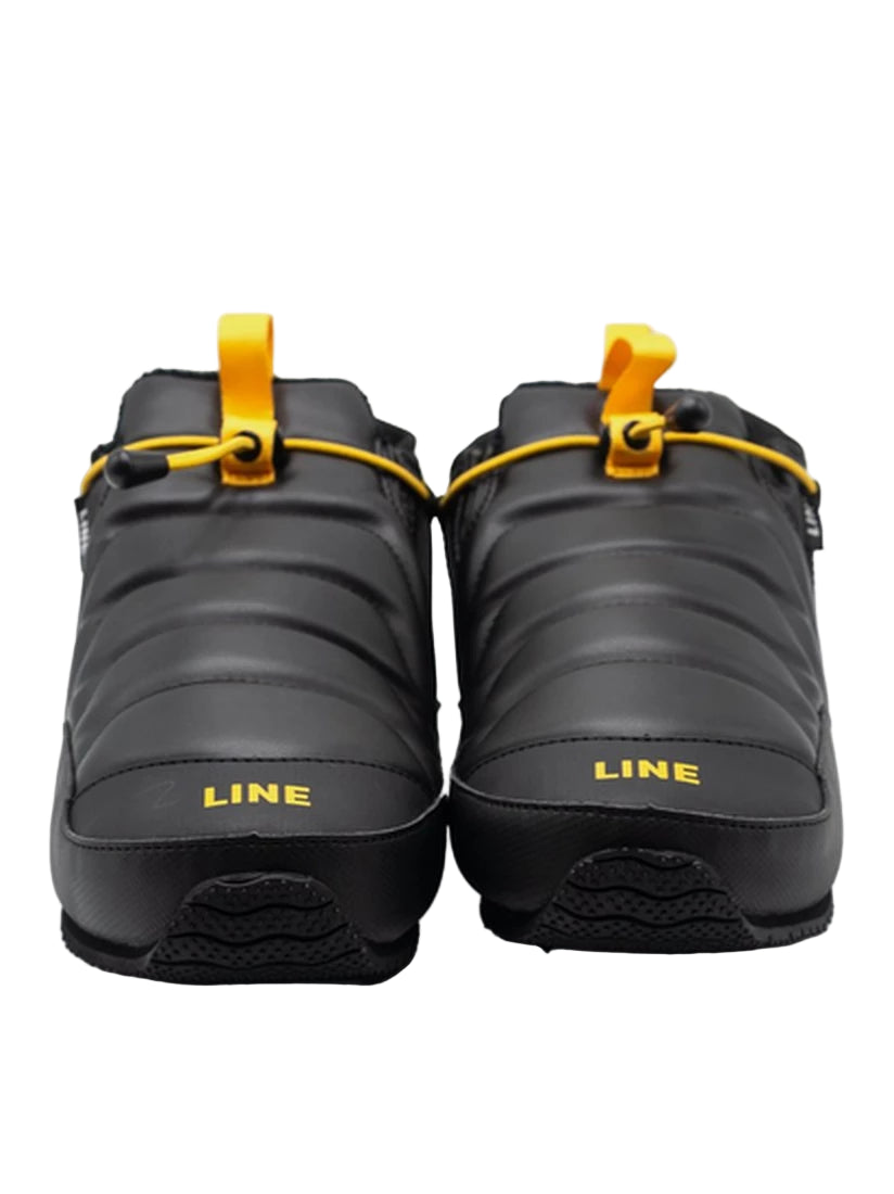 A pair of black snow boots with yellow accents and 'LINE' branding on a white background