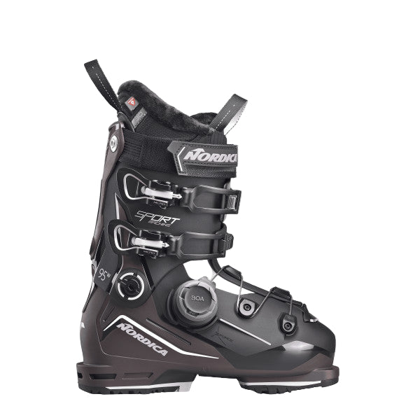 A  black ski boot shell with white over the instep and some white accents on the two buckles. the lower cuff has a BOA system attached.